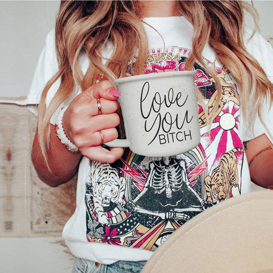 'Love You Bitch' mug held by a person wearing a colorful graphic tee, ideal for sassy coffee lovers and unique gift ideas.
