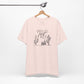 Light pink Wild and Free cactus graphic T-shirt on a hanger, offering a soft and stylish option for boho-inspired casual wear.
