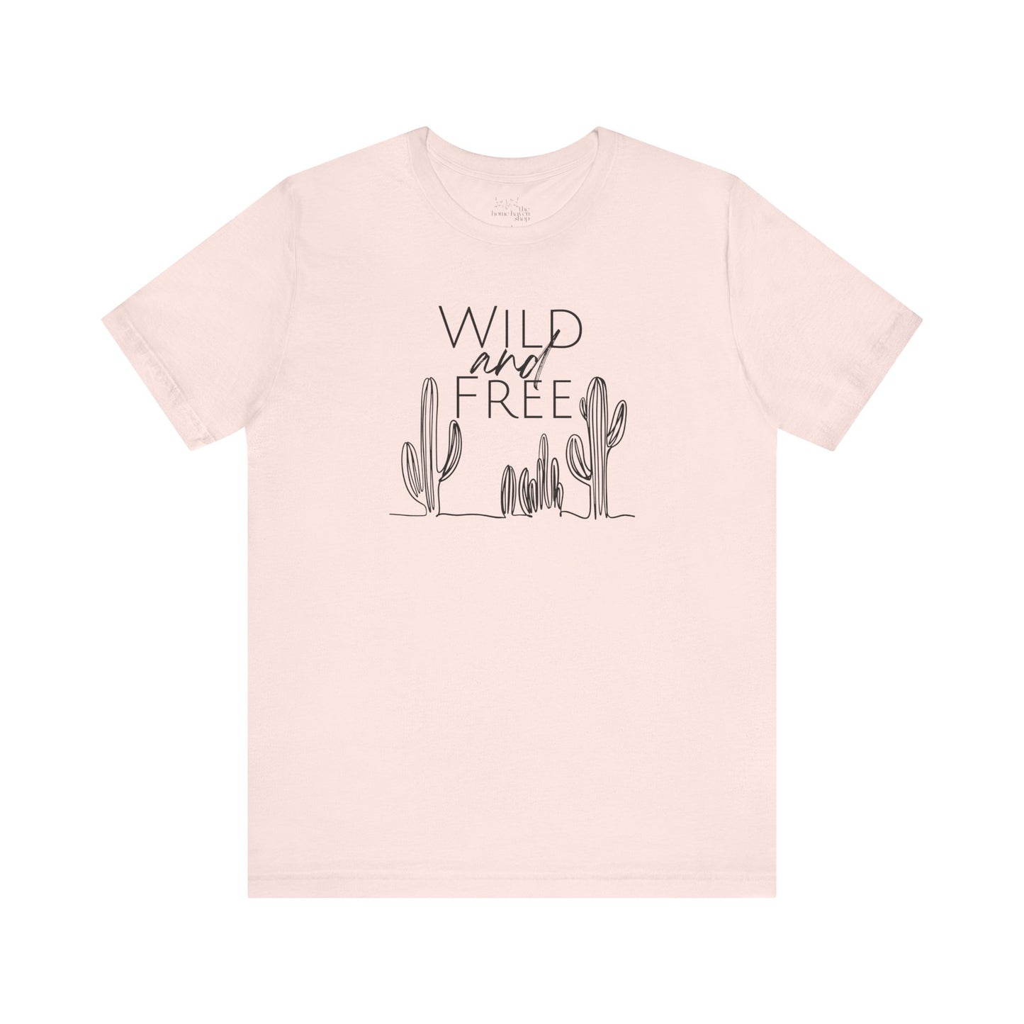 Light pink Wild and Free cactus graphic T-shirt laid flat, offering a soft and trendy option for boho-inspired wardrobes.