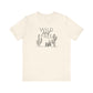 Cream Wild and Free cactus graphic T-shirt laid flat, highlighting a desert-inspired minimalist design for casual wear.