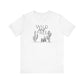 White Wild and Free cactus graphic T-shirt laid flat, featuring a minimalist desert-themed design for casual or boho outfits.