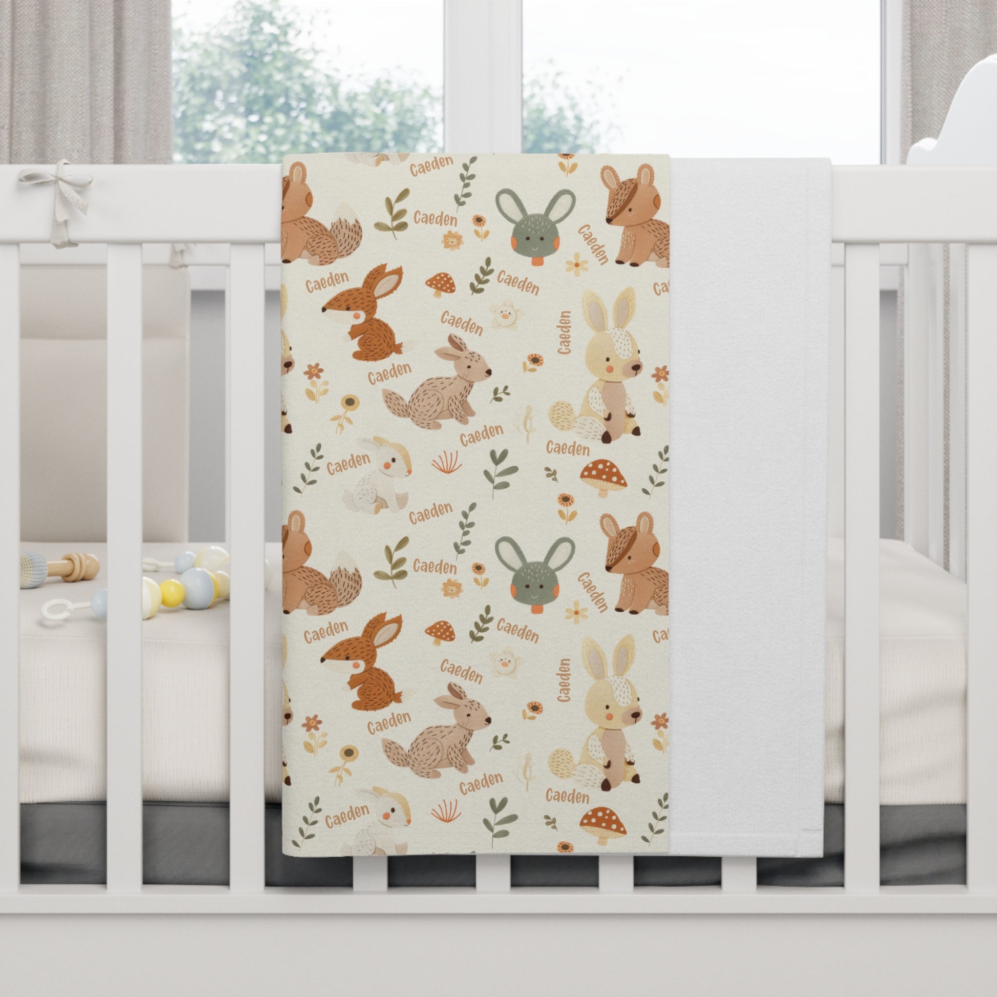 Personalized woodland animals baby blanket on crib