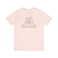 Just Vibes Graphic T-Shirt in light pink with minimalist floral design laid flat against a plain white background.