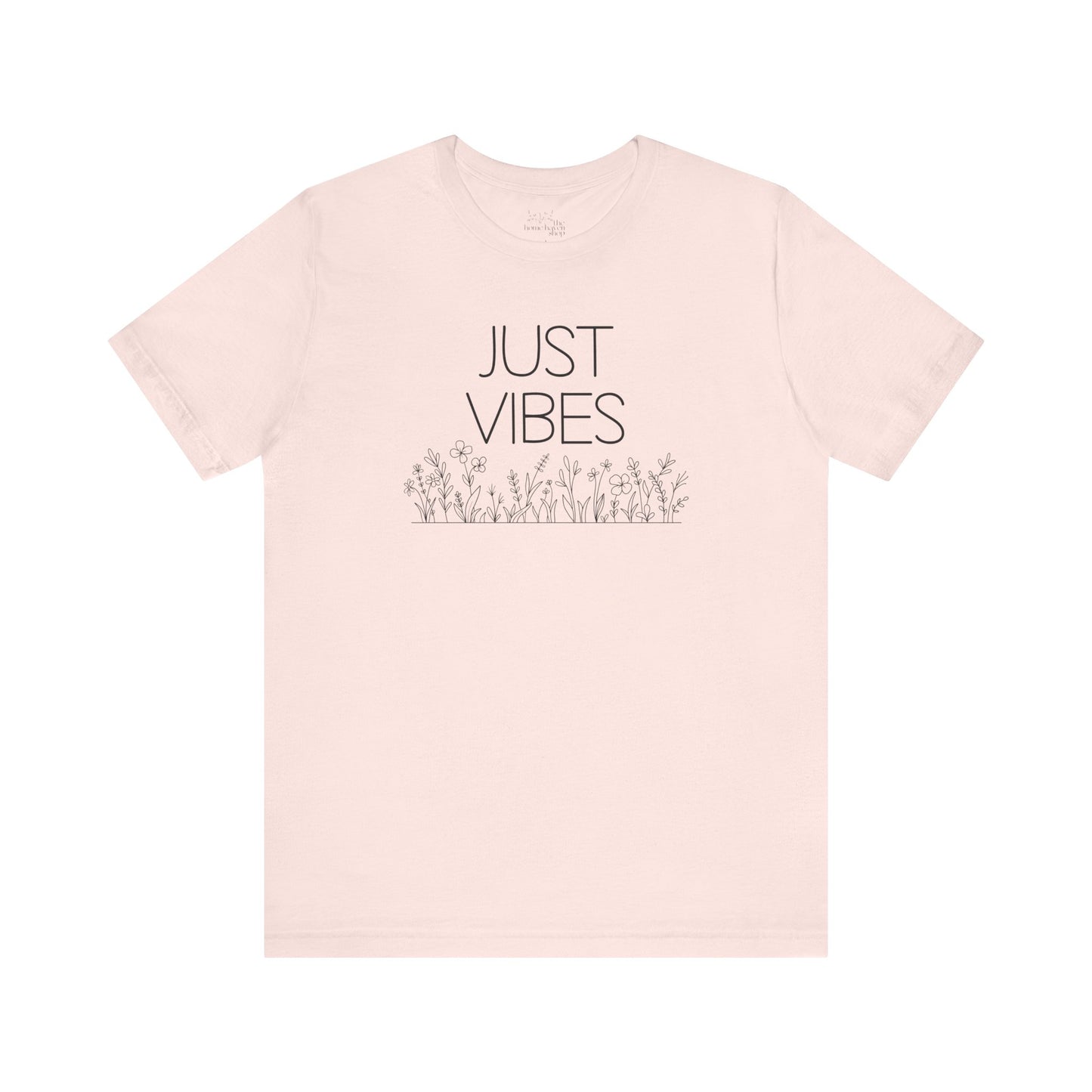 Just Vibes Graphic T-Shirt in light pink with minimalist floral design laid flat against a plain white background.