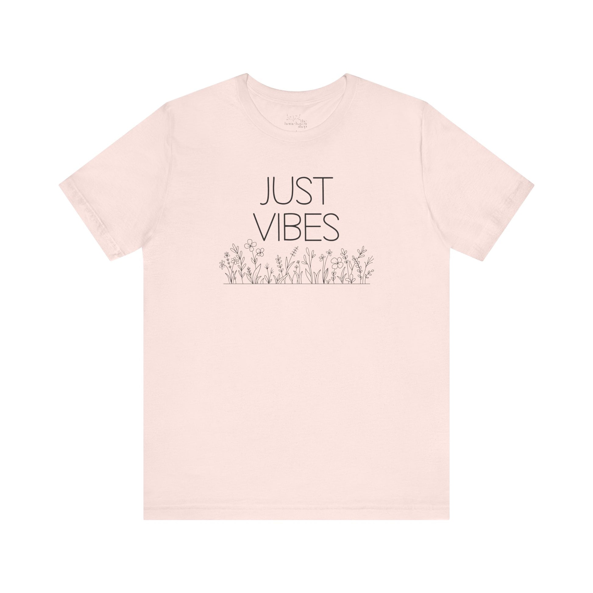 Just Vibes Graphic T-Shirt in light pink with minimalist floral design laid flat against a plain white background.