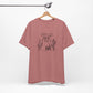 Rust-colored Wild and Free cactus graphic T-shirt on a hanger, showcasing minimalist boho design and soft cotton fabric.