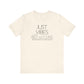 Just Vibes Graphic T-Shirt in cream color with minimalist floral design laid flat against a plain white background.