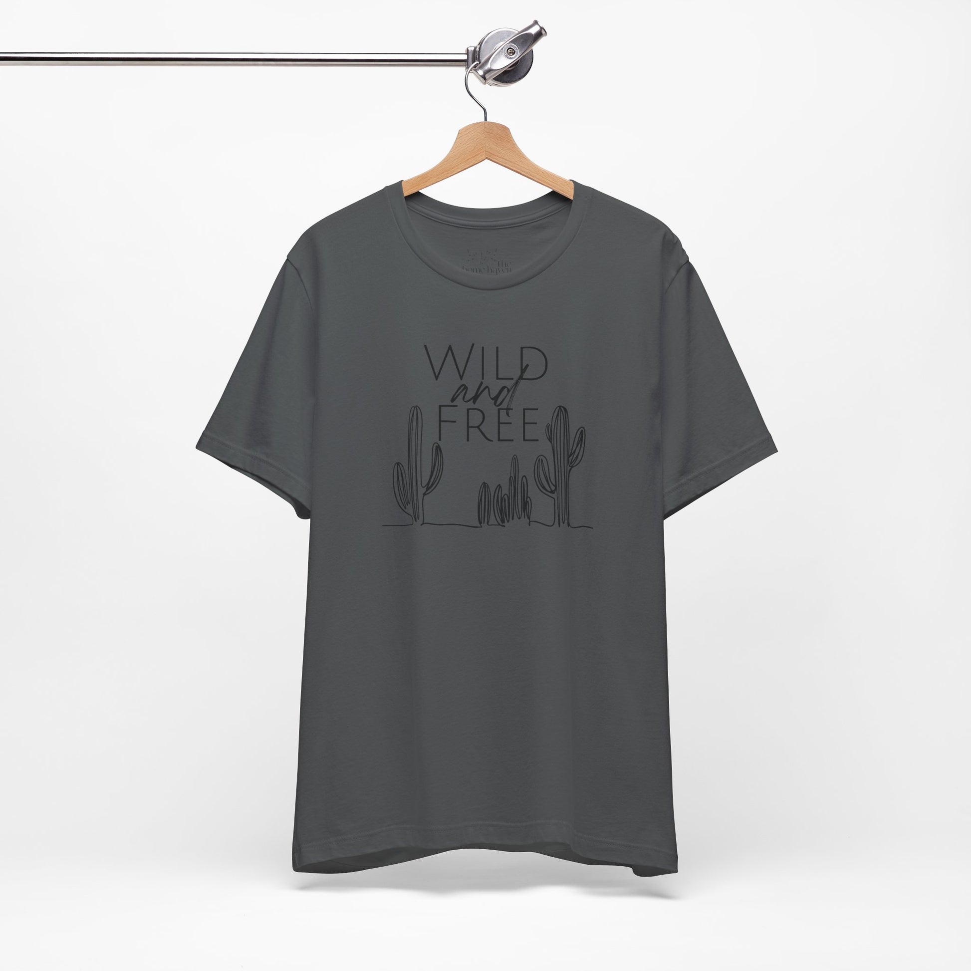 Charcoal Wild and Free cactus graphic T-shirt on a hanger, featuring a subtle boho design for outdoor and casual wear.