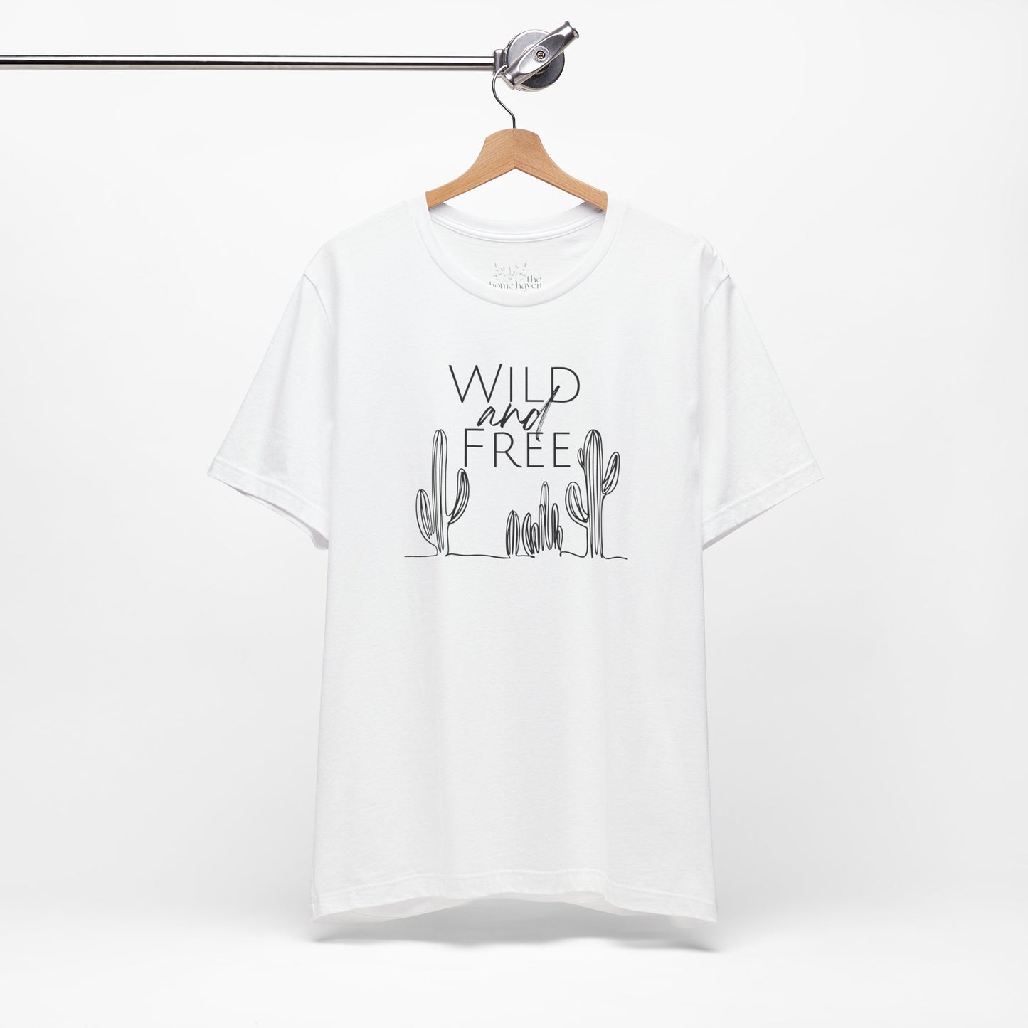 White Wild and Free cactus graphic T-shirt on a hanger, featuring a clean and minimalist design for boho and casual outfits.
