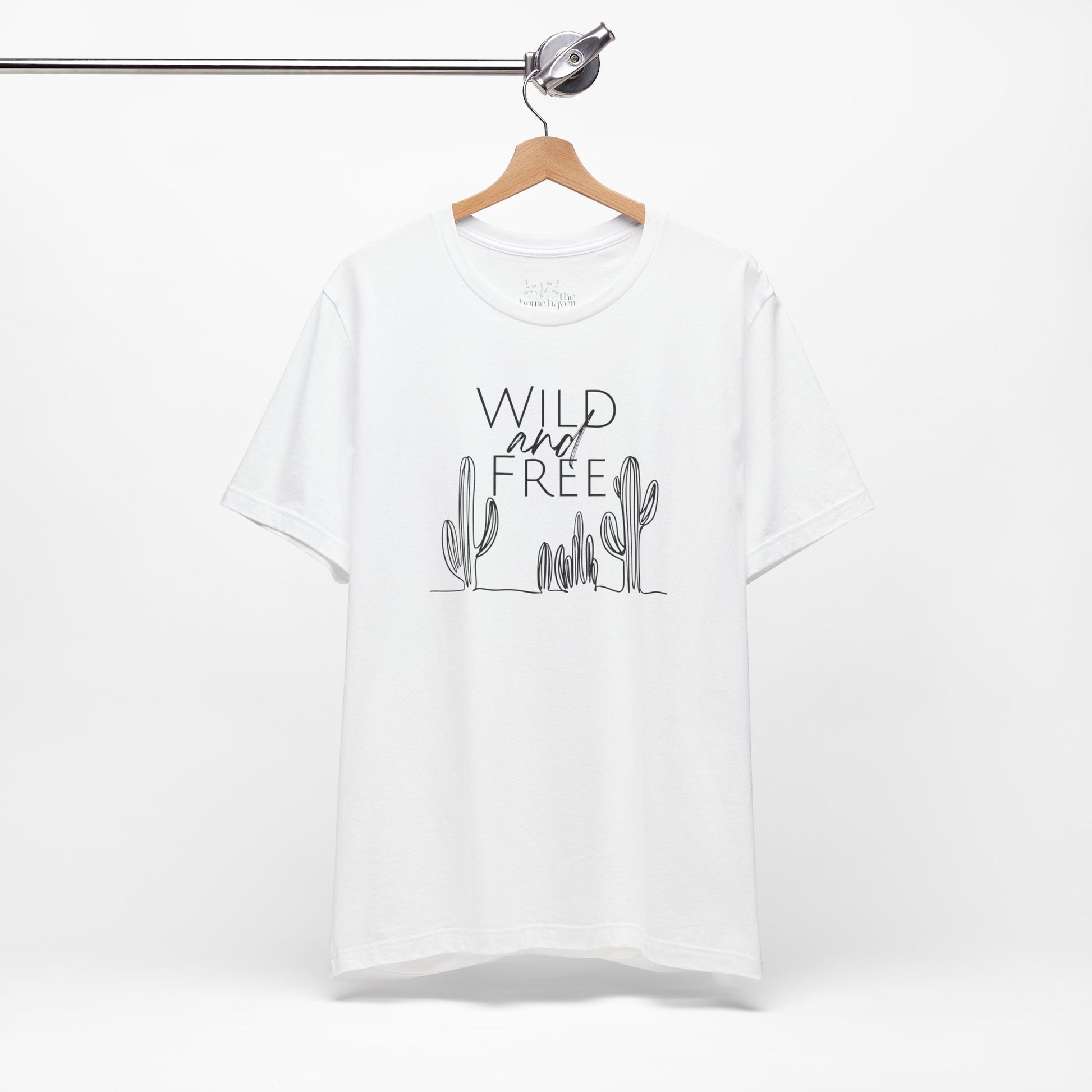 White Wild and Free cactus graphic T-shirt on a hanger, featuring a clean and minimalist design for boho and casual outfits.