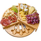 Bamboo cheese board with assorted cheeses and fruits.