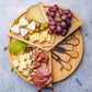 Close-up of bamboo cheese board with snacks.