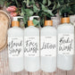 Set of 16oz white PET pump bottles labeled hand soap, face wash, lotion, and body wash. Stylish dispensers with floral and greenery accents.