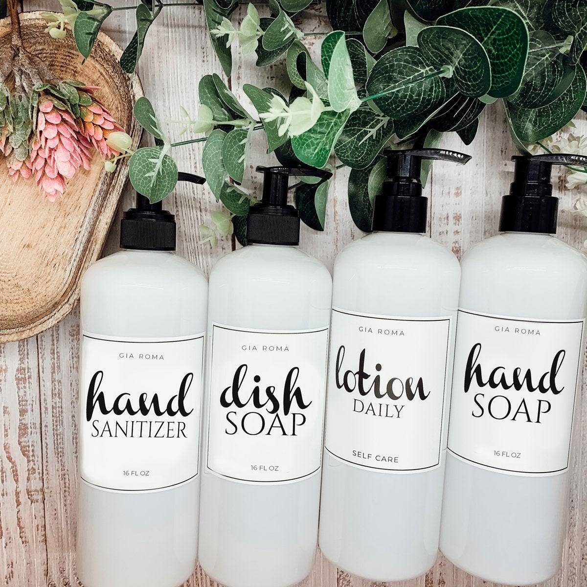 Set of 16oz white PET pump bottles labeled hand sanitizer, dish soap, lotion, and hand soap. Stylish dispensers with floral and greenery decor.