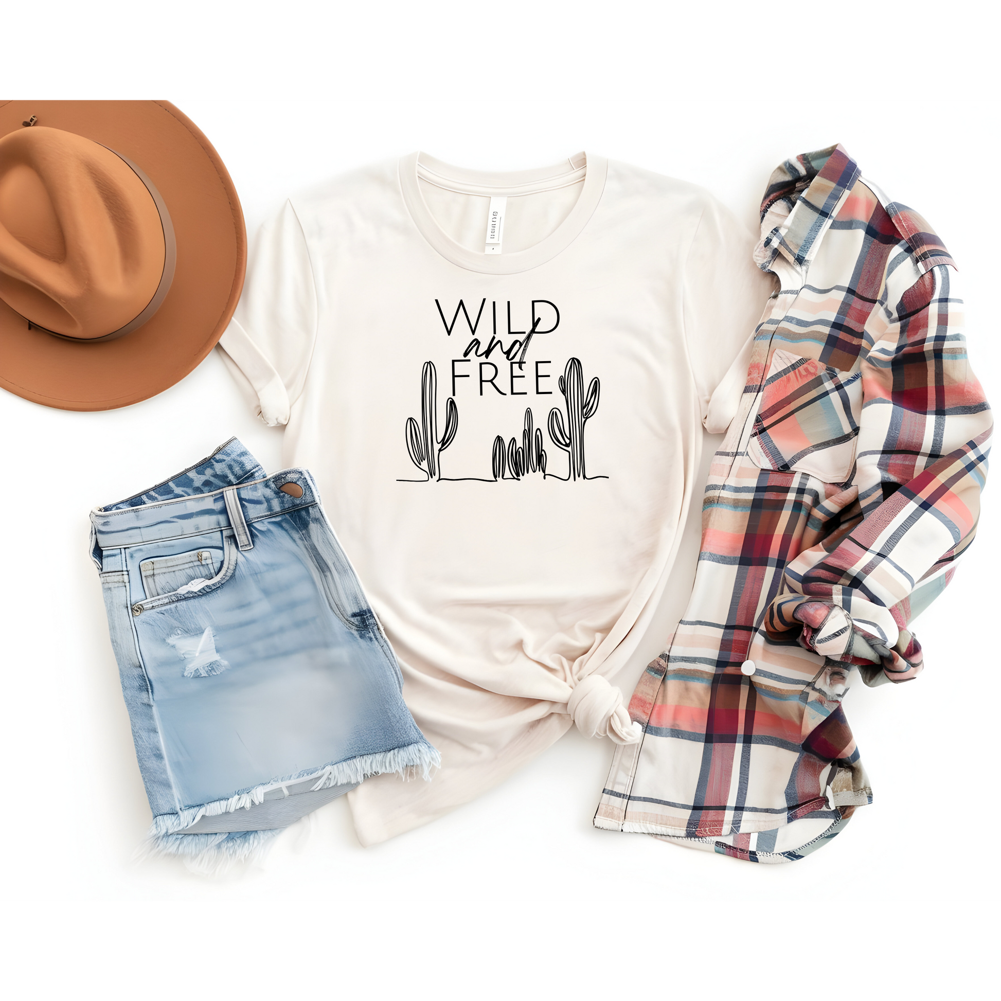 Boho casual cactus graphic T-shirt styled with denim shorts, plaid shirt, and a brown hat. Perfect for relaxed summer or festival looks.
