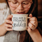 14.5oz ceramic coffee mug with 'You Are a Freaking Goddess' quote, held by a woman wearing glasses, enjoying her drink.