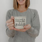 14.5oz ceramic coffee mug with 'You Are a Freaking Goddess' design, presented by a woman in a gray sweater.