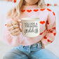 14.5oz ceramic coffee mug with 'You Are a Freaking Goddess' design, held by a woman in a pink sweater with heart patterns.