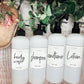 Set of 16oz white PET pump bottles labeled body wash, shampoo, conditioner, and lotion. Stylish dispensers with floral and greenery decor.